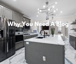 A dark gray kitchen with a large island.