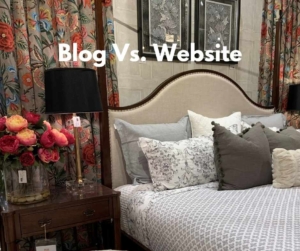A bed with flowers on the nightstand.