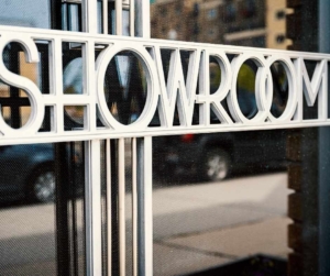A white showroom sign on a window.