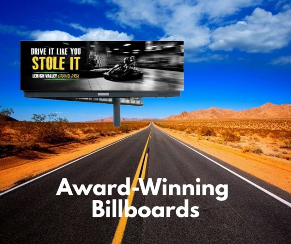 A road in the desert with a car billboard.