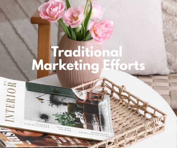 Home magazines on a table with flowers to advertise marketing efforts.