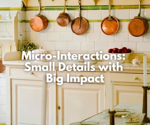 An off-white kitchen with hanging copper pots. Illustrates small details making impact on your website.